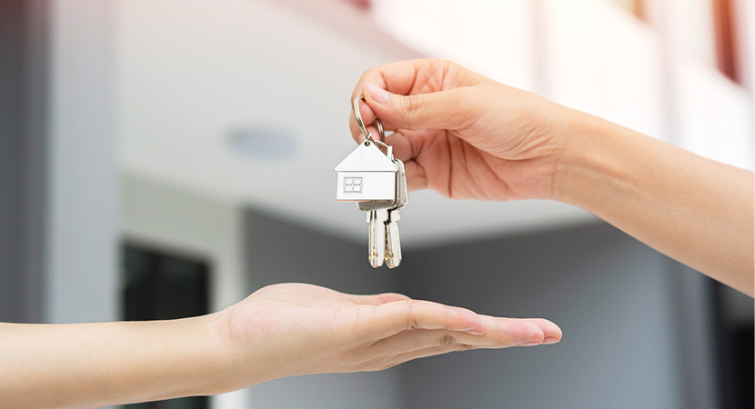 Person giving apartment keys to new resident